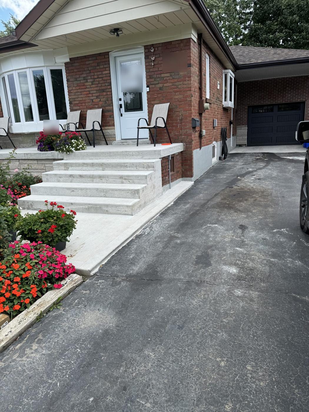 Finished detached brick garage with black carriage-style door at the end of the driveway, Bendale, Scarborough