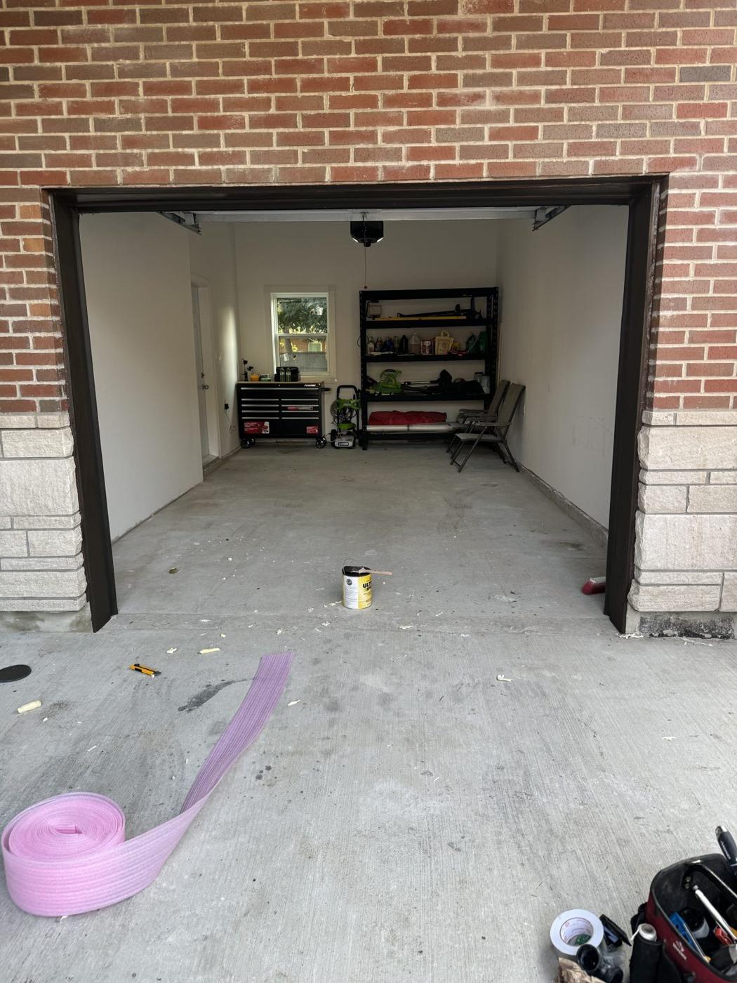 Interior of the finished detached garage with smooth concrete floor and finished walls
